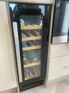 a refrigerator filled with lots of soda bottles at The Lodge in Selsey