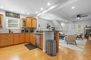 a kitchen with wooden cabinets and a table in a room at Blissful Boyne City Retreat: Luxurious & Modern! Sleeps 15! in Boyne City