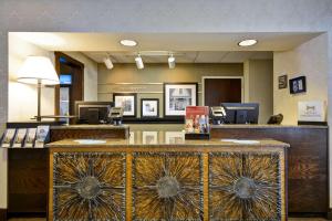 a lobby with a reception desk in a hotel at Hampton Inn Bozeman in Bozeman
