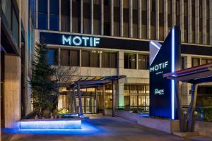 an office building with a motel sign in front of it at Hilton Motif Seattle in Seattle