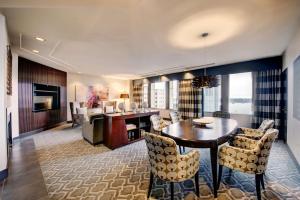 a dining room and living room with a table and chairs at Hilton Motif Seattle in Seattle