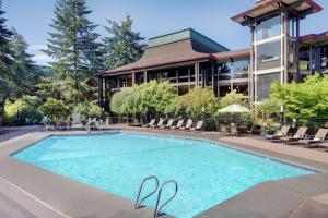 a swimming pool in front of a building at DoubleTree by Hilton Seattle Airport in SeaTac