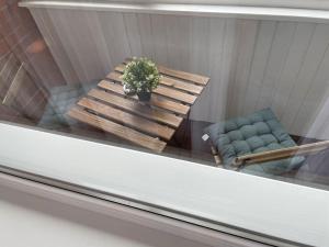 a table with a potted plant and two chairs at Žemaičiai in Panevėžys