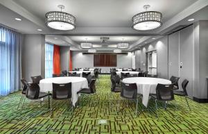 a conference room with tables and chairs in it at Hampton Inn by Hilton Calgary Airport North in Calgary