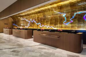 a lobby of a hotel with a gold wall at Hilton Columbus Downtown in Columbus