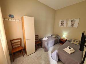 a bedroom with two beds and a door with a mirror at Casa Nautilus - 30m dal mare in Lampedusa