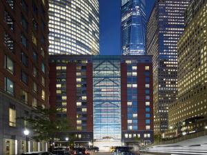 a tall building in a city with many tall buildings at Conrad New York Downtown in New York
