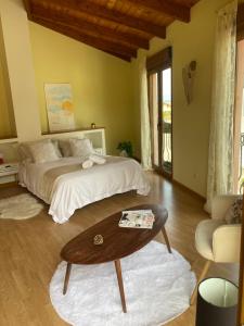 a bedroom with a bed and a coffee table at Montaña y Campo "Remanso de Paz" in Castropodame