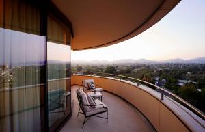 a balcony with chairs and a view of a city at Waldorf Astoria Beverly Hills in Los Angeles