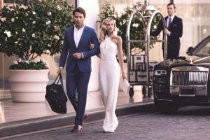 a man and a woman walking down a street at Waldorf Astoria Beverly Hills in Los Angeles