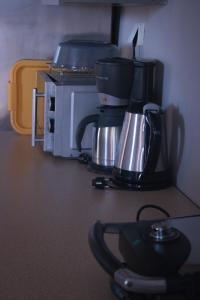 a coffee maker sitting on top of a microwave at Your Holiday Apartment in Kavála