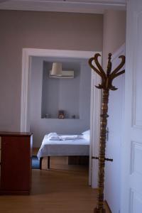 a bedroom with a bed and a pole in the corner at Your Holiday Apartment in Kavála