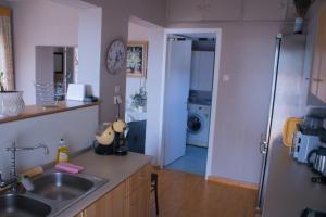 a kitchen with a sink and a counter top at Your Holiday Apartment in Kavála
