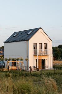 a house with solar panels on top of it at Apartamenty Na Łąkach in Kudowa-Zdrój