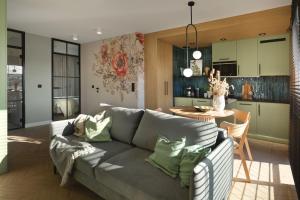 a living room with a couch and a dining room at Apartamenty Na Łąkach in Kudowa-Zdrój +26 photos