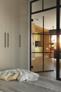 a bedroom with a sliding glass door leading to a kitchen at Apartamenty Na Łąkach in Kudowa-Zdrój