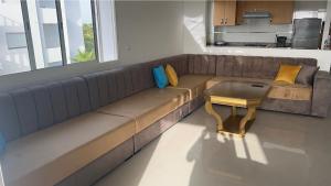 a couch in a living room with a table at Appartement 2 chambres vue mer - Marina Golf Asilah in Asilah