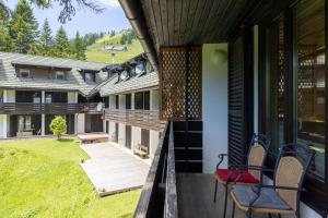 a balcony of a house with chairs on it at Apartma Krvavec in Cerklje na Gorenjskem