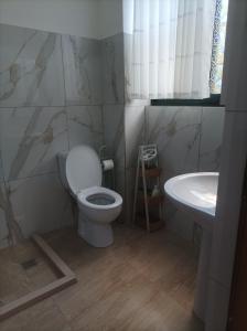 a bathroom with a toilet and a sink at Kleidi's home in Vlorë +14 photos