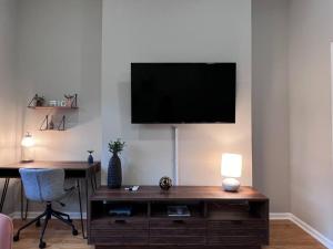 a living room with a desk and a television on a wall at Beautiful 1BD With Balcony Hosted By StayRafa - 2F in Philadelphia