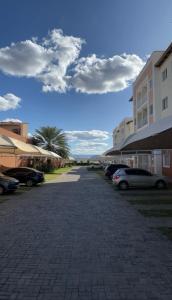 a parking lot with cars parked next to buildings at Apartamento em condomínio 24 hrs in Juazeiro do Norte