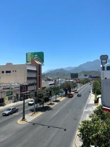 an empty street in a city with cars on it at Casa Nórdica - Monterrey in Monterrey