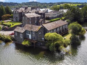 an old house on an island in the water at Pearsall in Ambleside