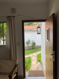 an open door to a house with a yard at La Casita in La Cumbre
