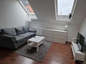 a living room with a couch and a table at Home Inn SVE102 in Stockholm