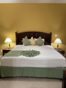 a bedroom with a large bed with two lamps at Hotel Centenario in Iguala de la Independencia
