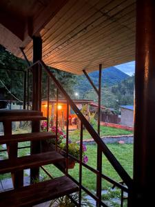 a view from the stairs of a house with mountains in the background at Guest House Lulu in Barisakho
