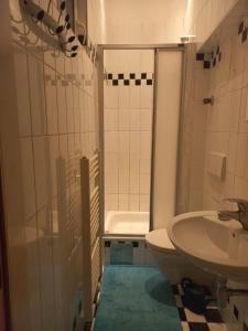 a bathroom with a sink and a toilet and a shower at Hostel Wieden in Vienna