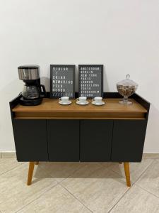 a counter with a coffee maker on top of it at Hostel Passa4 in Passa Quatro