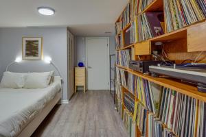 a bedroom with a bed and a book shelf filled with books at Pet-Friendly Staatsburg Studio - Near State Park 