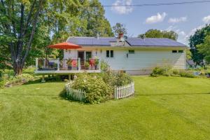 a house with a deck with an umbrella at Pet-Friendly Staatsburg Studio - Near State Park 