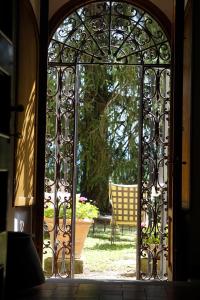 an open door to a patio with a chair in the yard at Residenza Villa Degli Ochi in Sagginale
