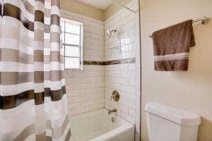 a bathroom with a tub and a toilet and a shower at Spacious Baton Rouge Home Rental 12 Mi to LSU! in Baton Rouge +22 photos