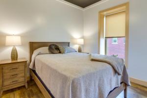 a bedroom with a bed and a window at Downtown Millersburg Retreat with Sleek Interior! in Millersburg