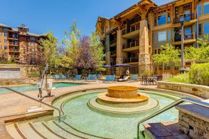 a pool with a fountain in front of a building at Canyons Sunrise in Park City