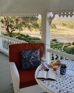 a table with books and a plate of food on a porch at Beltane Ranch in Glen Ellen