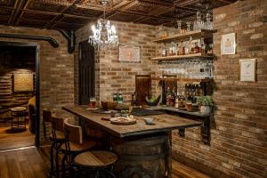 a bar with a wooden counter and a brick wall at Pillow and Paddock B&B in La Grange
