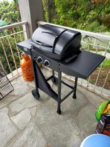 a black grill sitting on top of a patio at Varenna Wonders, Villa with pool for 14 guests in Perledo