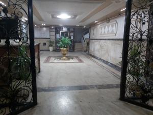a hallway with a door with a plant in it at شقة فندقية علي البحر مباشرة بجليم in Alexandria