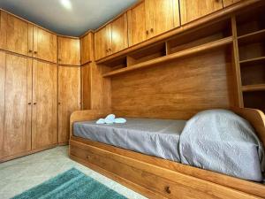 a bedroom with a bed with wooden walls and shelves at Timeless Elegance: Vintage 3-Bedroom Apartment 