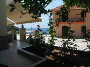 a view of a house with the ocean in the background at Dimitris Apartments in Vasiliki