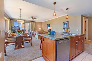 a kitchen and living room with a table and a dining room at HK #539 in Lahaina