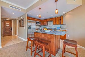 a kitchen with a large island with wooden counter tops at HK #537 in Lahaina