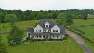 an aerial view of a house on a green field at Pillow and Paddock B&B in La Grange