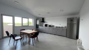 a kitchen with a table and chairs in a room at Hotel Lavanda in Piteasca