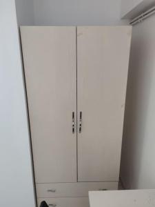 a white closet with white cabinets in a room at Expérience urbaine in Aubervilliers